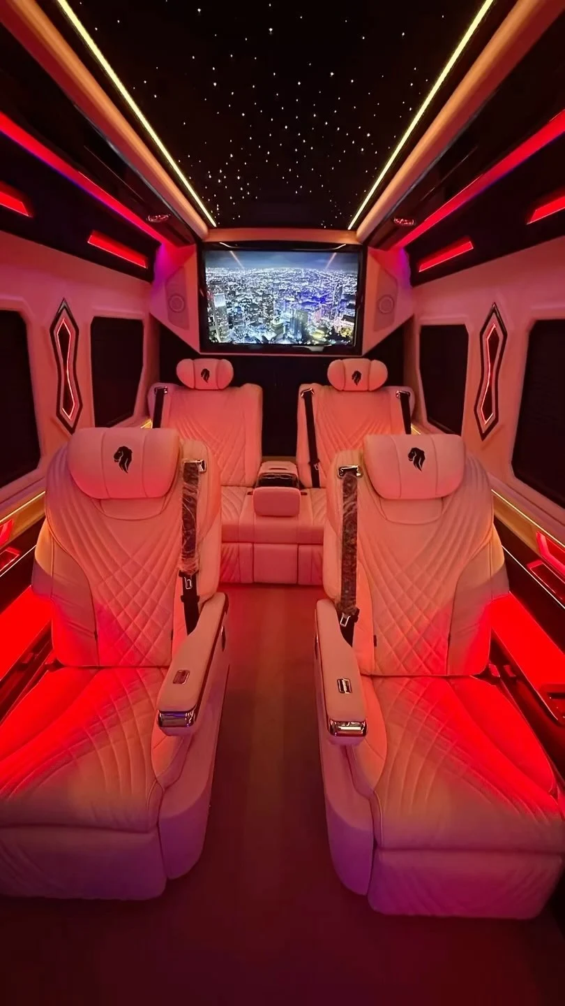 White VIP seats beneath a starlight ceiling and red ambient lighting